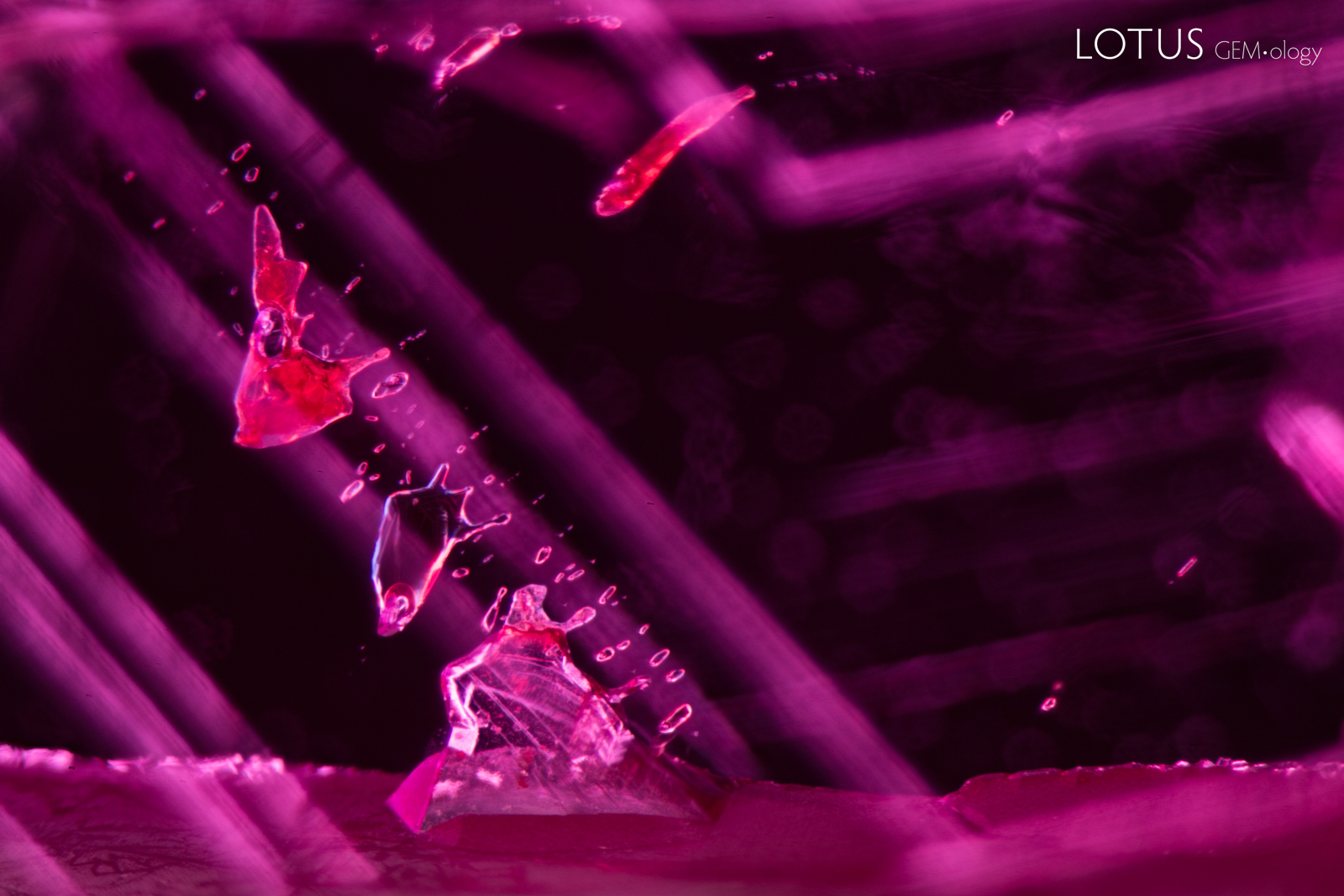 Douros synthetic flux ruby with growth markings and flux crystals.