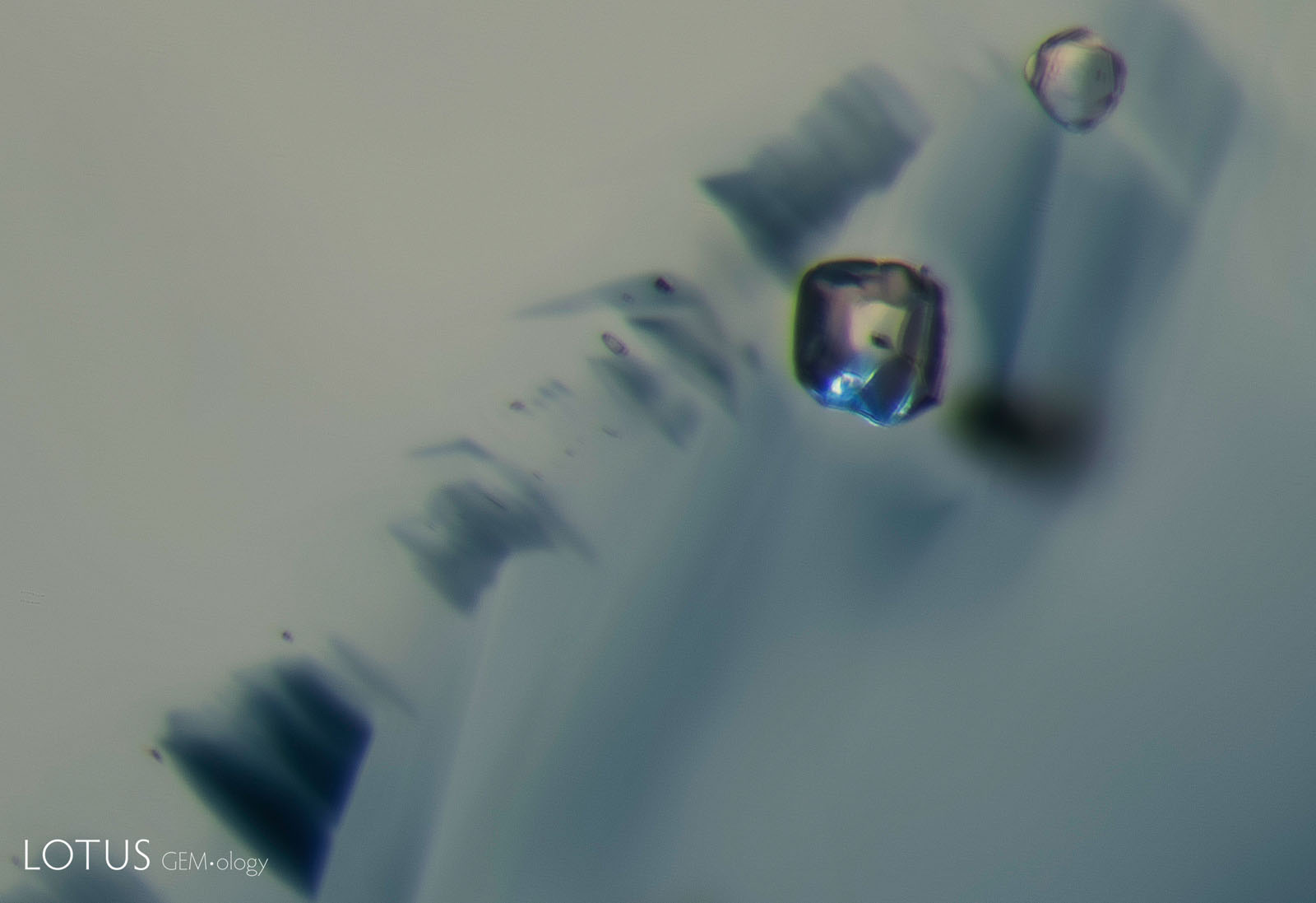 A: Before heating, sample 9 shows two transparent crystals next to a pattern of angular blue color zoning.