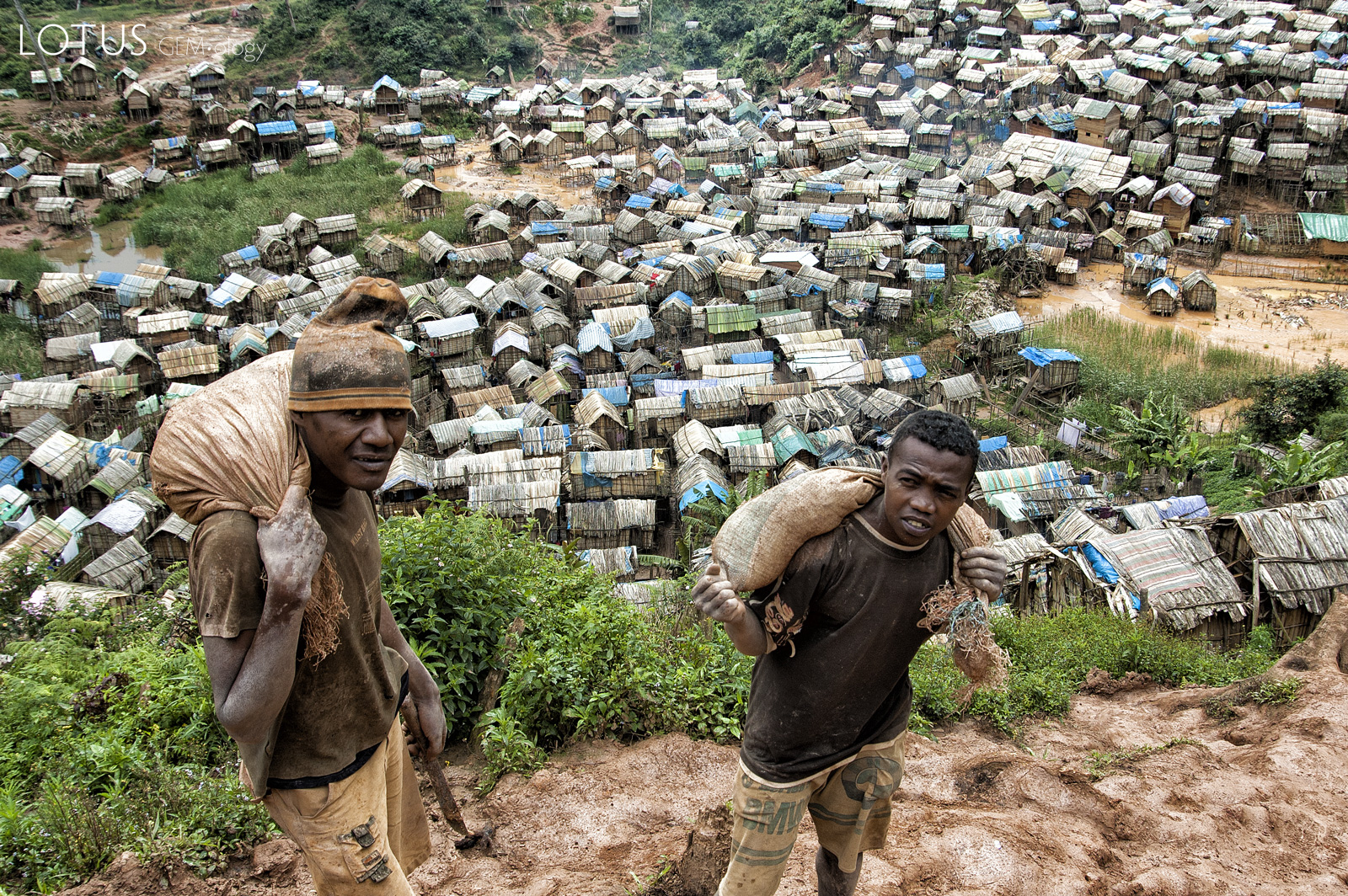 Malagasy miners carrying gem-bearing gravel above Moramanga village, deep in the Madagascar bush. Photo: R.W. Hughes, September 2005.