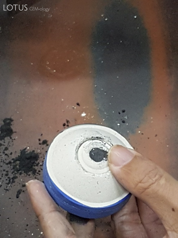 Typically a few drops of water are placed into the crucible with the graphite (left). After the crucible is full (right), it is sealed with a small ceramic ring and a plate of molybdimum (not shown).