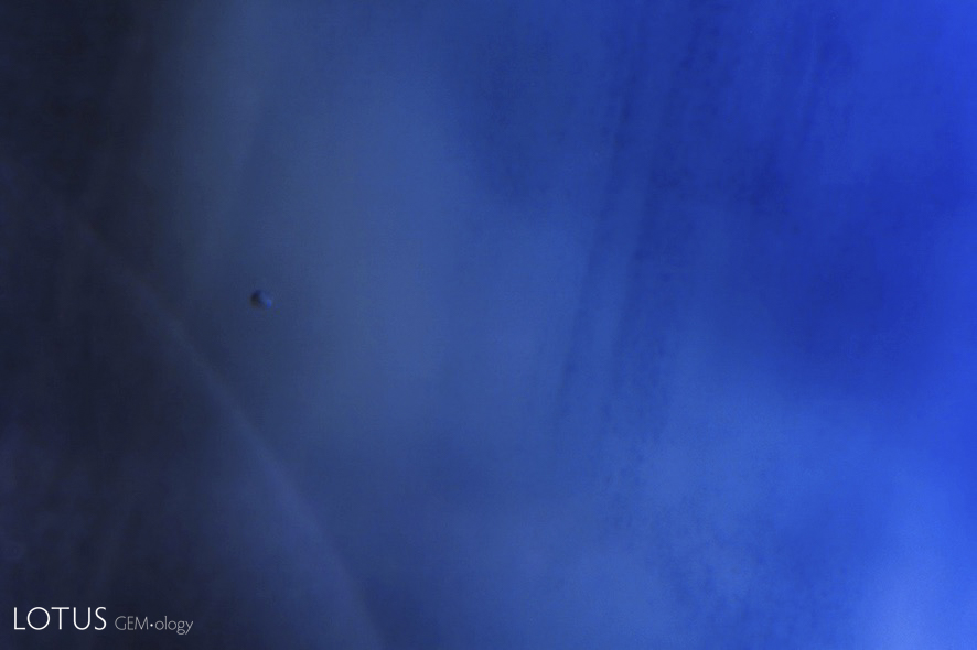 Pressure-heated sapphire before (left) and after (right) treatment. In this case, there was improvement in clarity due to the healing of the narrow-gap fissure at lower left and the halo around the crystal inclusion.