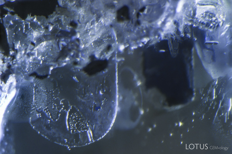 Pressure-heated sapphire before (left) and after (right) treatment. In this case, after heating with pressure the iron staining was gone, while the fissure in the middle partially healed, but was still quite visible.