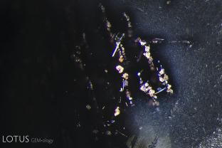 Two kinds of silk are visible in this star spinel: a fine, dense cloud of tiny needles as well as larger reflective platelets.
