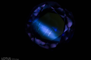 Verneuil synthetic color change sapphire showing curved chalky fluorescent growth structure in a powerful shortwave ultraviolet light.