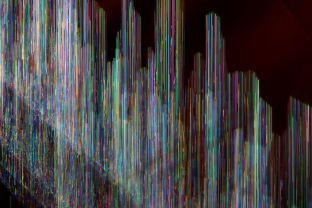 Dislocation needles create microscopic city skyline in this red spinel.
