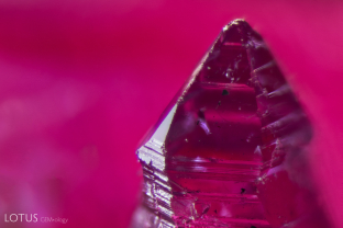 A small twin crystal attached to a larger Knischka ruby crystal.